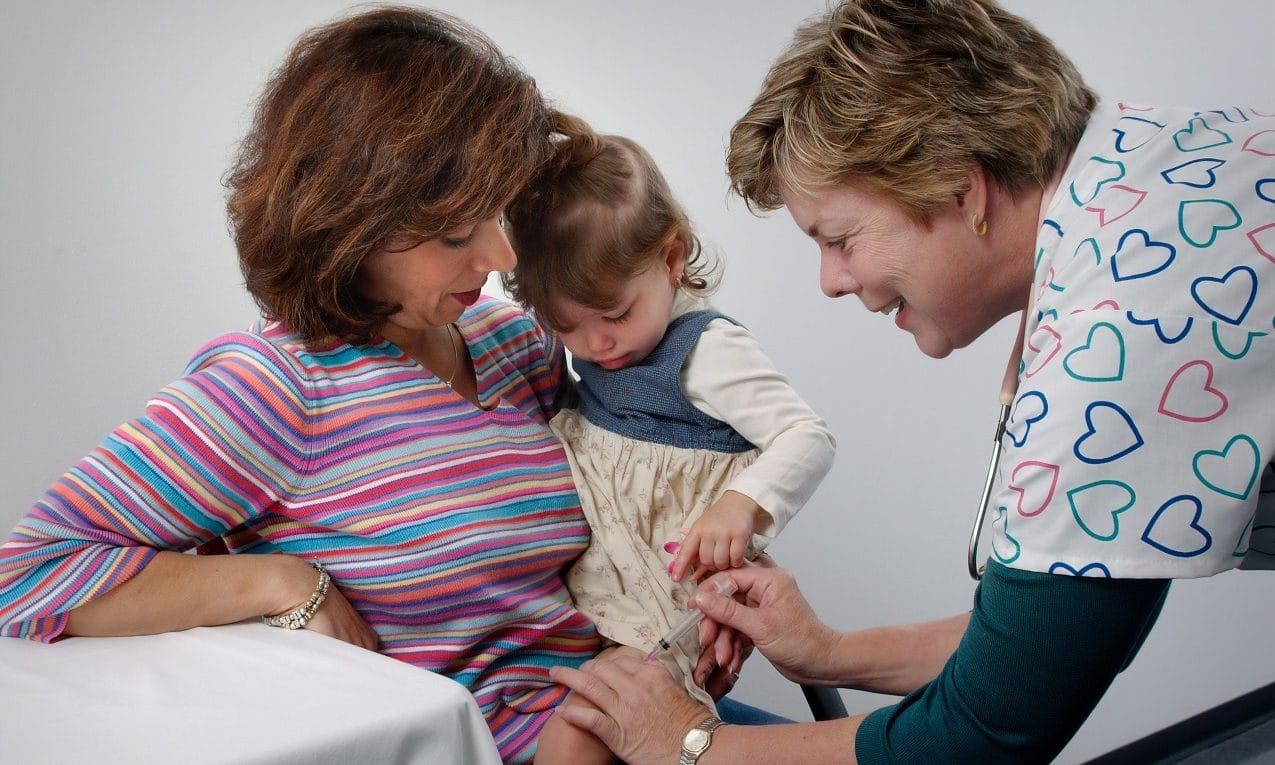 Doctor vaccinating a baby girl