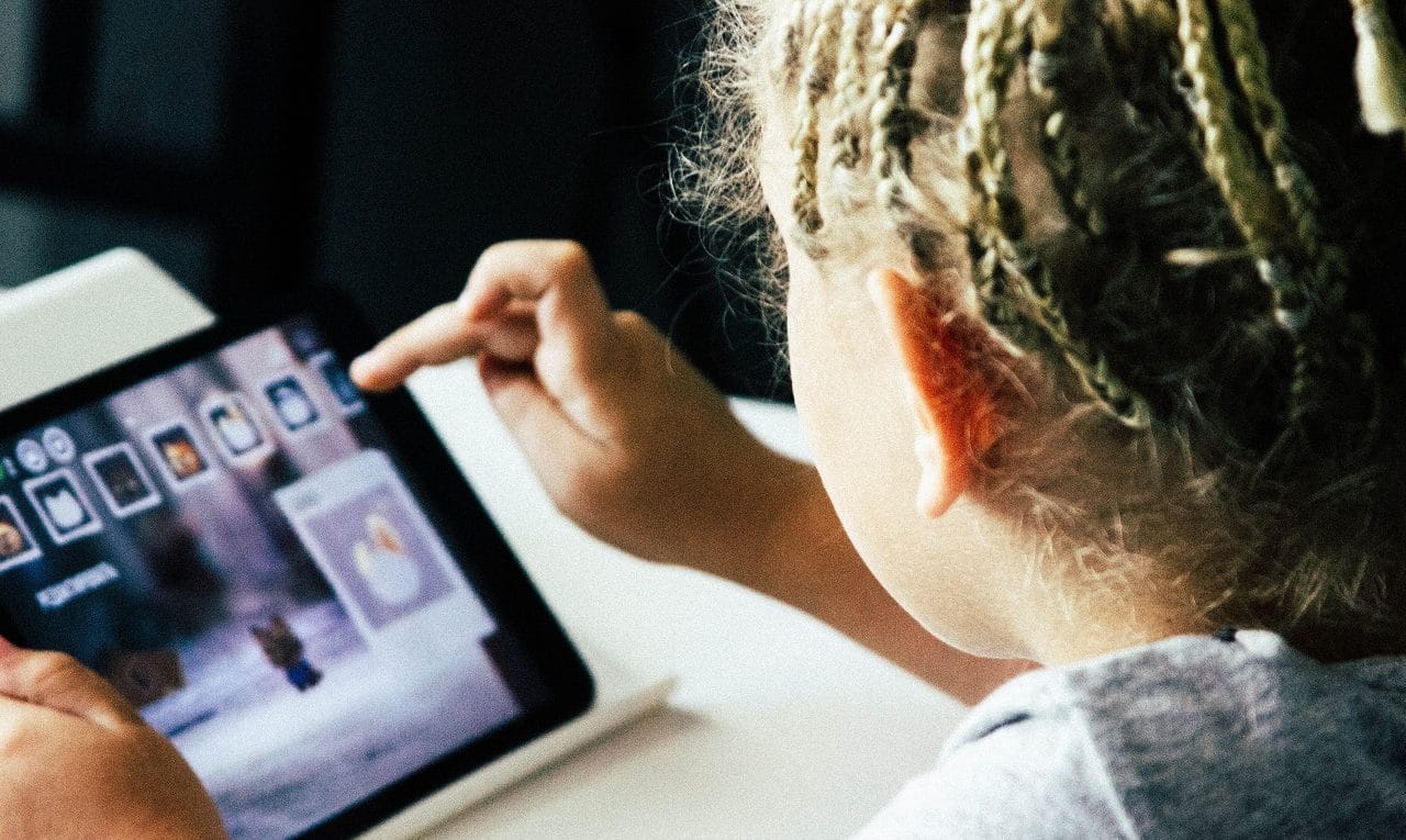 Kid playing on his tablet