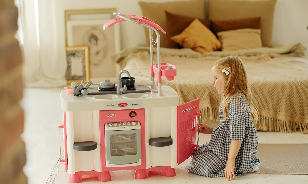 little girl playing best kitchen set toys